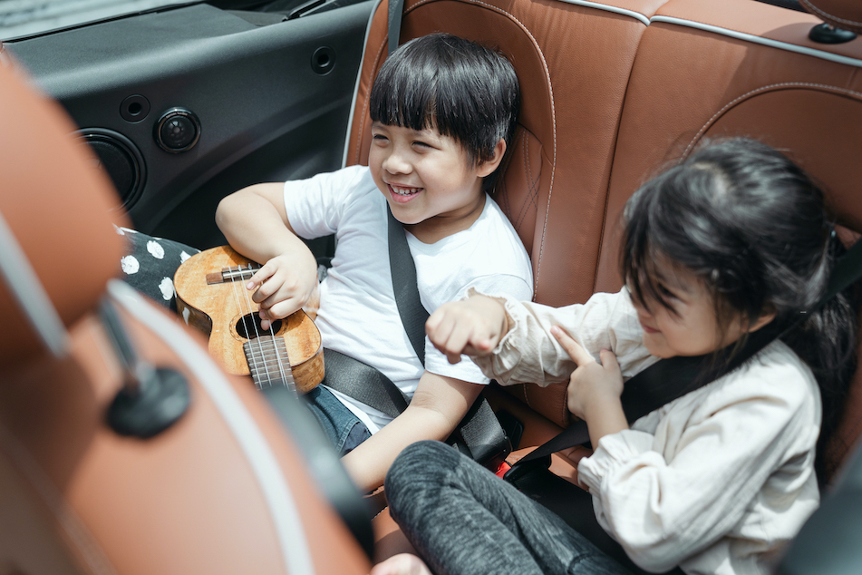 Canva Happy Asian kids traveling in car